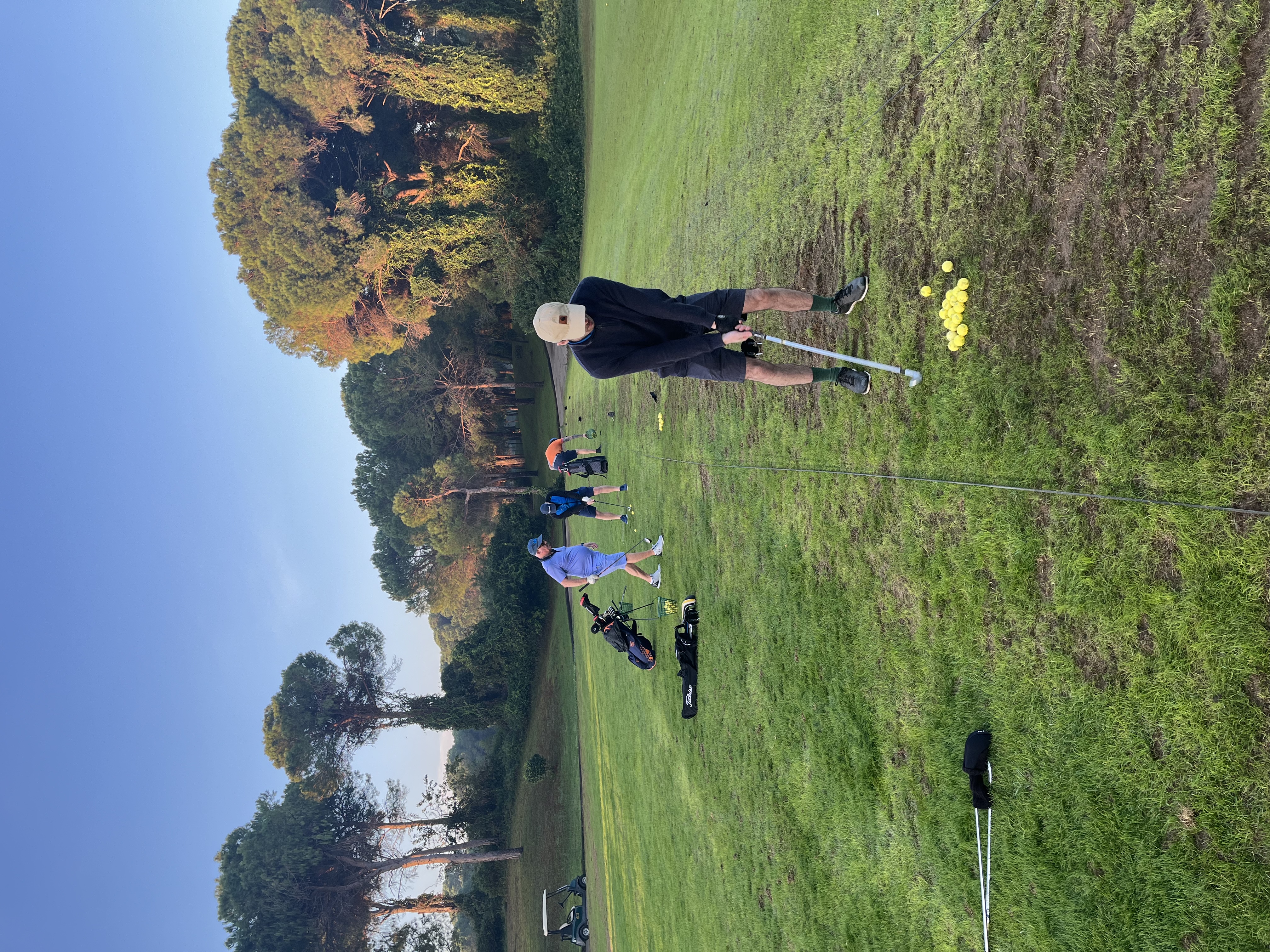 Group coaching session at the driving range